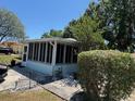 Enclosed Florida room offers additional living space with views of the landscaped yard at 406 E Grove Ave, Lake Wales, FL 33853
