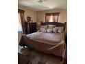 Comfortable main bedroom with soft lighting, a plush bed, and neutral decor at 406 E Grove Ave, Lake Wales, FL 33853