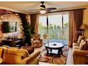 Inviting living room featuring a ceiling fan, balcony access, and neutral decor at 13415 Blue Heron Beach Dr # 304, Orlando, FL 32821