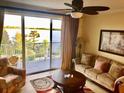 Bright living room with a water view, balcony access, and comfortable seating at 13415 Blue Heron Beach Dr # 304, Orlando, FL 32821