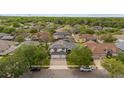 Aerial shot of a home in a verdant neighborhood with tree-lined streets at 1559 Wescott Loop, Winter Springs, FL 32708