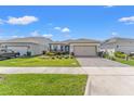 Beautiful one-story home with a well-maintained lawn and paved driveway at 2019 Spring Shower Cir, Kissimmee, FL 34744