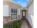 Stylish front door with stone accents and lush landscaping at 2019 Spring Shower Cir, Kissimmee, FL 34744