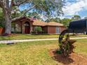 Lovely single-story home with a well-manicured lawn, featuring an American flag at 20249 Macon Pkwy, Orlando, FL 32833