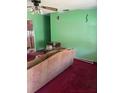 Cozy living room featuring green walls, patterned sofa, and a vintage ceiling fan at 2117 Lemon St, Haines City, FL 33844