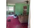 Cozy living room featuring green walls, patterned sofa, and a vintage ceiling fan at 2117 Lemon St, Haines City, FL 33844
