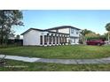 Inviting two-story home with a beautiful lawn, showcasing the front facade at 2227 Coventry Dr, Winter Park, FL 32792