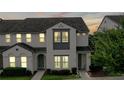 Elegant two-story townhome featuring stylish architectural details and manicured front yard at 228 Captiva Dr, Davenport, FL 33896