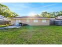 Spacious backyard with a grassy lawn, small patio, and lots of natural light at 2535 Georgia Ave, Sanford, FL 32773