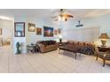 Open living room featuring tile floors, ceiling fan, and neutral walls, perfect for relaxation at 271 Falling Waters Dr, Kissimmee, FL 34759