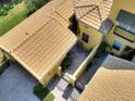 Birds-eye view of the tiled roof, private courtyard, and exterior architecture of this lovely home at 2724 Palm Tree Dr, Poinciana, FL 34759