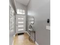 Welcoming entryway with neutral walls, tiled floors, and an arched display niche, bathed in natural light at 3111 Turnberry Blvd, Kissimmee, FL 34744