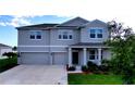 Attractive two-story home featuring a two-car garage, covered entry, and well-kept lawn at 4190 Bull St, St Cloud, FL 34772