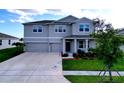 Charming two-story home featuring a spacious driveway, manicured lawn, and inviting covered porch at 4190 Bull St, St Cloud, FL 34772