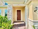 Inviting front entrance with stone accents and a brick walkway at 5019 Down Ct, St Cloud, FL 34772