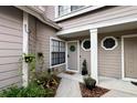 Inviting entryway with covered porch, decorative plants, and charming exterior details at 554 Northbridge Dr, Altamonte Springs, FL 32714