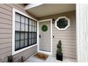 Close-up of front door with wreath, welcome mat, and exterior details at 554 Northbridge Dr, Altamonte Springs, FL 32714
