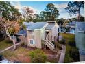 Aerial view of the home overlooking a lake and featuring a private stairwell at 6040 Peregrine Ave # A01, Orlando, FL 32819