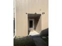 Front entrance of home featuring neutral siding, a tile entry and the house number at 6040 Peregrine Ave # A01, Orlando, FL 32819