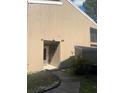 Front entrance of home featuring neutral siding and the house number at 6040 Peregrine Ave # A01, Orlando, FL 32819