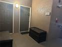 Apartment entryway featuring doors, an outdoor bench, and a unit number 303 sign at 6141 Metrowest Blvd # 303, Orlando, FL 32835