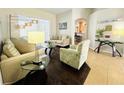 Cozy living room featuring stylish furniture, abundant natural light, and an open floor plan at 618 N Hampton Dr, Davenport, FL 33897