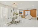 Open concept living room with modern chandelier, wall art, and natural light at 6632 Pasturelands Pl, Winter Garden, FL 34787