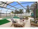 Screened in pool area with comfortable seating at 6714 Bouganvillea Crescent Dr, Orlando, FL 32809
