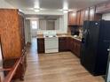 Spacious kitchen featuring dark cabinetry, modern appliances, and hardwood flooring at 6937 Gibraltar Rd, Orlando, FL 32822