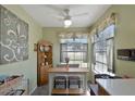 Well-lit eat-in kitchen with ceiling fan, natural light and breakfast nook with seating for a casual dining experience at 7218 Alston Ct, Orlando, FL 32835