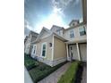 Charming two-story townhome with neutral siding, stone accents, and a brick walkway at 7544 Sunville Ave # 7544, Kissimmee, FL 34747