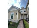 Charming two-story townhome with neutral siding, stone accents, and a brick walkway at 7544 Sunville Ave # 7544, Kissimmee, FL 34747