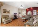 Spacious living room features hardwood floors, comfortable seating, and plenty of natural light at 801 Ashton Dr, Davenport, FL 33837