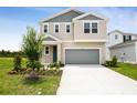 Charming two-story home with an attached garage and well-maintained front lawn featuring manicured landscaping at 816 Lake Dell Rd, Dundee, FL 33838