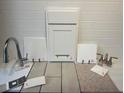 A curated selection of interior finish materials, showcasing cabinet doors, flooring samples, and countertop options at 816 Lake Dell Rd, Dundee, FL 33838