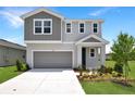 Charming home showcasing modern architectural design, lush front lawn and landscaped yard at 824 Lake Dell Rd, Dundee, FL 33838