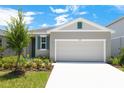 Inviting single-story home with a two-car garage, pristine driveway, and tastefully painted exterior with matching shutters at 828 Lake Dell Rd, Dundee, FL 33838