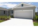 Well-maintained home featuring a two-car garage, ample driveway space, and freshly landscaped surroundings at 828 Lake Dell Rd, Dundee, FL 33838