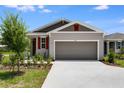 A well maintained, modern single-Gathering home with a two-car garage and a well-groomed front yard at 832 Lake Dell Rd, Dundee, FL 33838