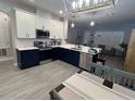 Modern kitchen featuring stainless steel appliances, two-tone cabinets and a tile backsplash at 9803 Sweetleaf St, Orlando, FL 32827