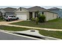 Single story home featuring a two-car garage, manicured lawn, and traditional design at 1104 Star Ruby Ln, Winter Haven, FL 33880