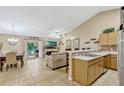 Inviting living space with tile flooring, ample natural light, comfortable seating, and adjacent kitchen area at 1150 Jade East Ln, Kissimmee, FL 34744