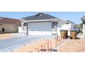 A white single-Gathering home with a two-car garage and a spacious driveway at 121 Lochness Ln, Kissimmee, FL 34743