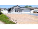 Beautiful single-Gathering home with a spacious driveway and a well-manicured lawn at 121 Lochness Ln, Kissimmee, FL 34743