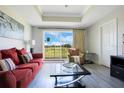 Inviting living room with contemporary furnishings, neutral walls, and a scenic outdoor view through the window at 1311 Seven Eagles Ct # 202, Reunion, FL 34747
