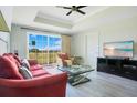Bright living room featuring modern decor, large windows with golf course view, and comfortable seating at 1311 Seven Eagles Ct # 202, Reunion, FL 34747