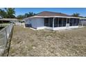 A backyard with a chain link fence and a screened lanai offers privacy and comfort at 15106 Sw 38Th Cir, Ocala, FL 34473