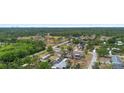 Wide aerial shot showcasing the neighborhood with a sports field and lush green surroundings at 18806 Monroe Ave, Orlando, FL 32820