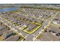 Beautiful aerial view highlighting property lines in a neighborhood near a lake at 19283 Allium Pl, Orlando, FL 32827