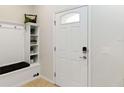 Welcoming entryway with a built-in bench and storage, plus a stylish front door at 1995 Majorca Dr, Kissimmee, FL 34747